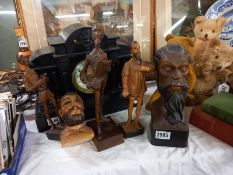 Three carved wood figures and a carved wood bust.