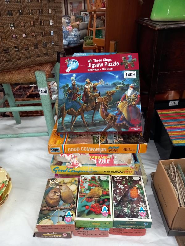 A collection of approximately 20 boxed jigsaw puzzles, unchecked