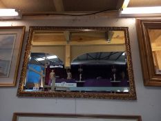 A gilt framed bevel edged mirror. 83 cm x 58cm. COLLECT ONLY