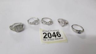Five assorted silver rings.