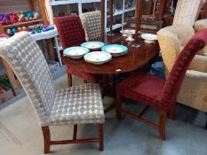 An oval extending twin pedestal dining table with four upholstered dining chairs. COLLECT ONLY.