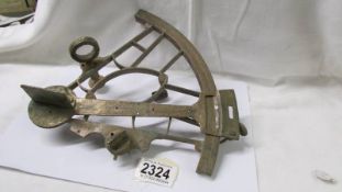 An antique brass sextant (metal detector find).