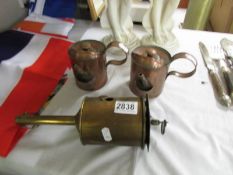 A Victorian brass spit roaster and two old copper oil cans.