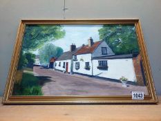 A painting on board of cottages signed EAB 1986