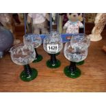 A set of 6 green stemmed wine glasses