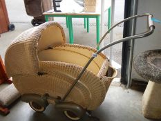 A circa 1920/30's wicker Lloyd Loom style baby pram. COLLECT ONLY.