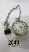 A pocket watch with heavy silver Albert chain.