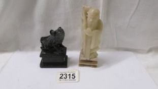 A soapstone figure of a man and a Dog of Fo figure.