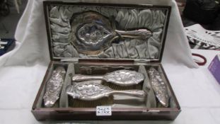 A cased 19th century silver set comprising 4 brushes, a comb and a hand mirror, WD Birmingham, 1863.