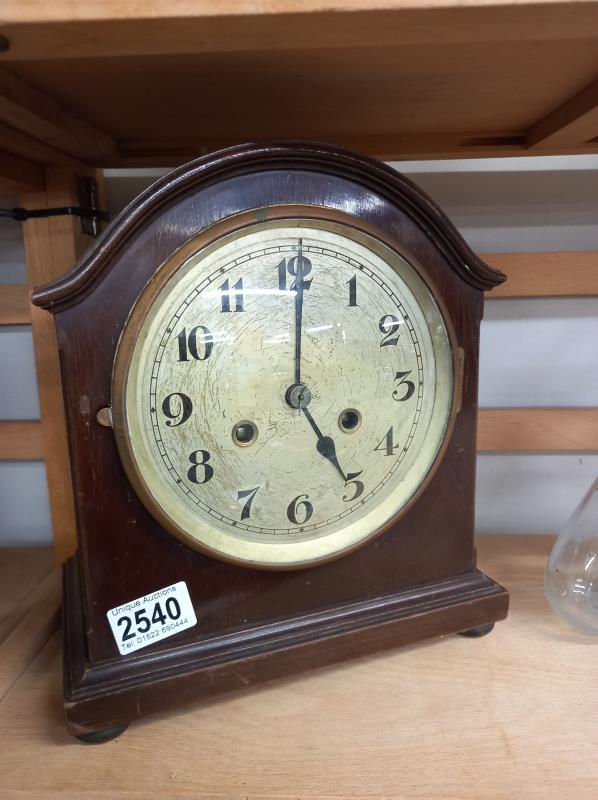 An eight day mahogany mantel clock in working order.