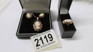 A 9ct gold cameo ring, a 9ct gold cameo and a pair of 9ct gold cameo earrings.