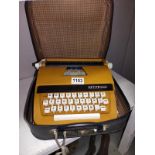 A cased vintage Petite International Delux typewriter