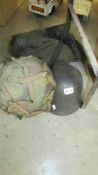 Two metal helmets and a kit bag.