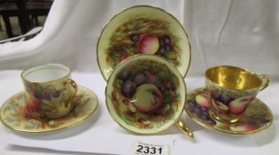 Three Aynsley fruit decorated tea cups and saucers.
