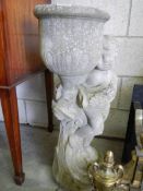 A tall garden planter on cherub base, 76cm tall, in good condition. COLLECT ONLY.