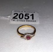 A ruby and diamond yellow gold ring, size N.