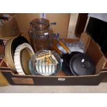 A box of kitchen items including cast iron saucepans & bakery dishes etc.