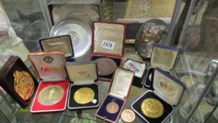 A collection of medallions including Victoria, Charlotte of Luxemburg, football, boxing etc.,