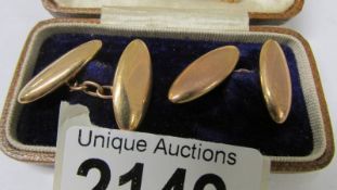 A pair of 15ct gold cuff links and a 15ct gold tie pin, 6.5 grams.