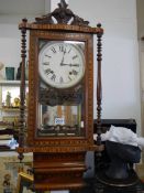 A good quality mahogany inlaid wall clock in good condition but missing pendulum, COLLECT ONLY.