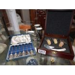 A cased set of 6 coffee spoons & a cased wine cork set etc.