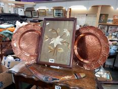 A pair of hammered copper plates, an original boomerang & a period embroidered flower picture