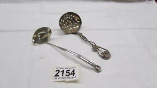 A silver sifter spoon and a small Danish silver ladle, 50 grams.