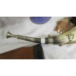 An old hunting horn with brass embellishments.