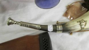 An old hunting horn with brass embellishments.