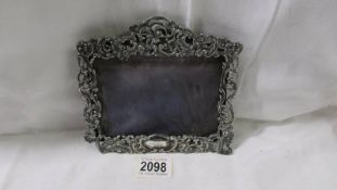 An ornate silver photo frame, a/f.