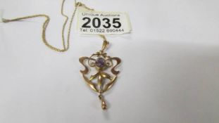 A Victorian 9ct gold pendant on chain set amethyst.