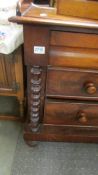 A mahogany two over two chest of drawers with barley twist columns, COLLECT ONLY.