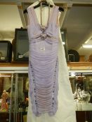 A Versace purple women's evening dress with chain metal detail and original tags with dress cover.