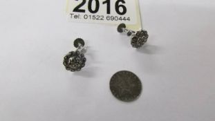 A pair of silver marcasite earrings and a silver 1858 USA 3 cent coin.