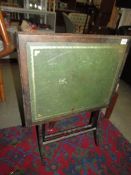 A folding card table with leather top. COLLECT ONLY.