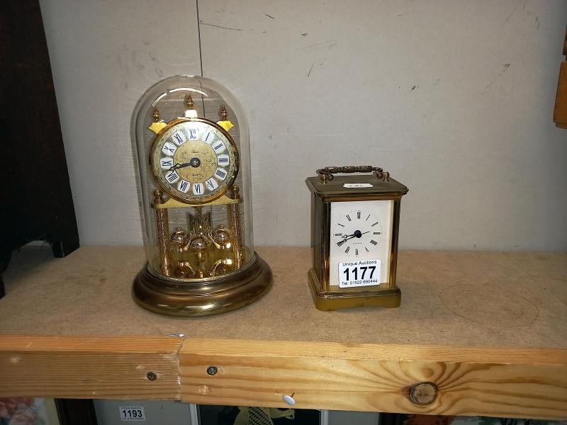 A brass Quartz carriage clock & anniversary clock under glass dome