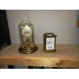 A brass Quartz carriage clock & anniversary clock under glass dome