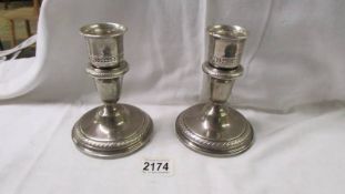 A pair of sterling silver candlesticks.