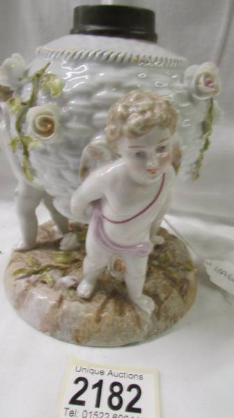 A continental porcelain cherub oil lamp base. - Image 2 of 2