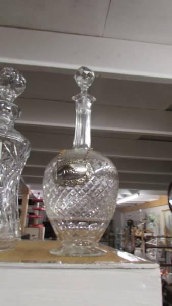 A pair of cut glass decanters with labels and another cut glass decanter. - Image 2 of 3