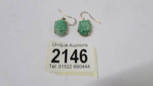 A pair of 18ct jadite earrings.