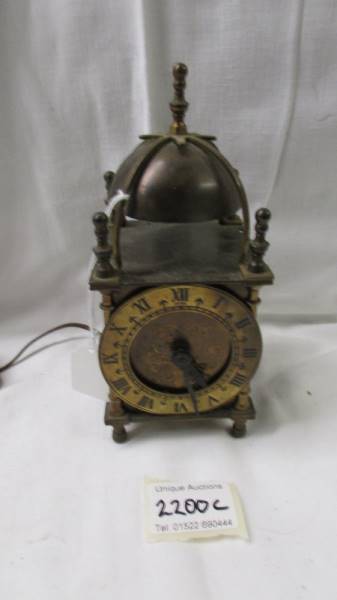 An old electric brass lantern clock.