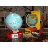 A boxed vintage Chad Valley tinplate globe of the world.