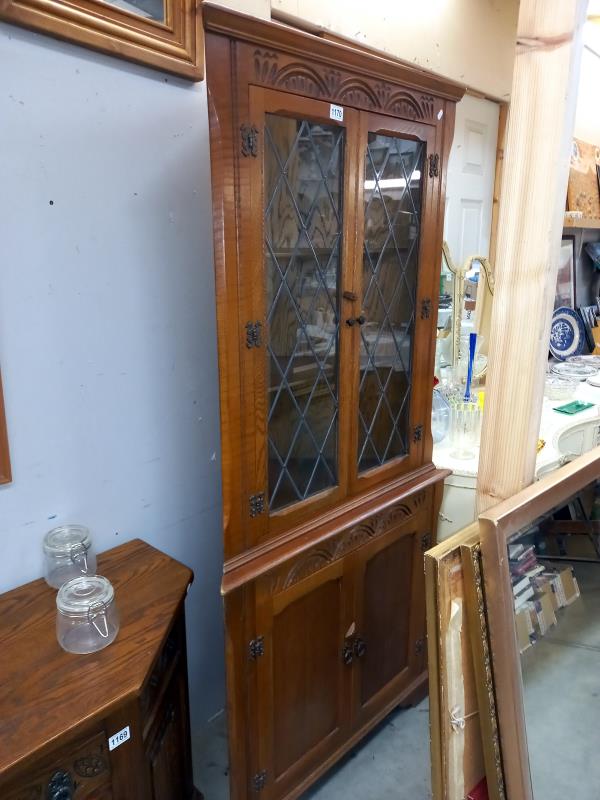 A modern oak corner cupboard with leaded glass doors COLLECT ONLY