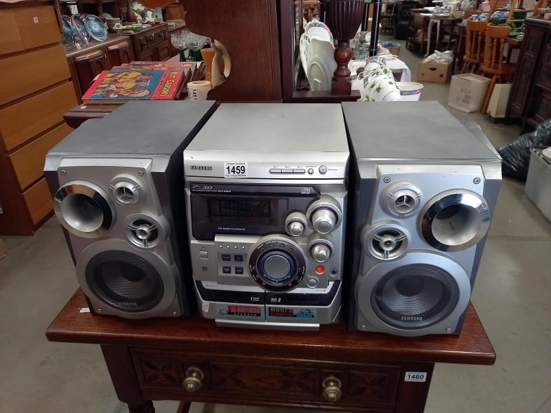 A Samsung stereo with speakers, 3 CD changer player, radio tuner & double tape deck (model - MAX-