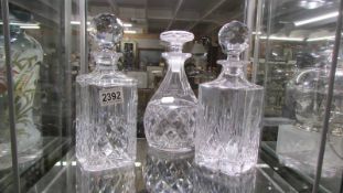 Three cut glass decanters.