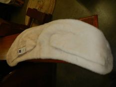 A Michael Kors white real fur scarf with original price tags.