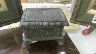 A small decorative metal casket.