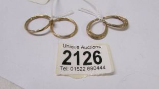 Two pairs of 9ct gold fancy hoop earrings.