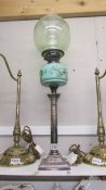 A silver? based column oil lamp with green glass font. COLLECT ONLY.